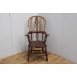 Oak Windsor armchair raised on turned legs with turned stretcher {117 cm H x 64 cm W x 50 cm D}.