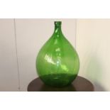Green glass wine bottle {66 cm H x 42 cm Dia.}.