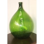 Green glass wine bottle {66 cm H x 42 cm Dia.}.