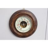 Edwardian carved oak barometer with ceramic dial {30 cm Dia.}.