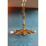 Unusual fourteen branch brass chandelier in the form of a wheel decorated with Roman warriors. {70