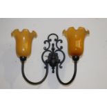 Pair of black metal wall lights with amber tulip shades {36 cm H x 45 cm W x 22 cm D}.