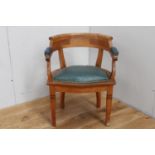 Oak armchair with leather upholstered seat {80 cm H x 60 cm W x 50 cm D}.