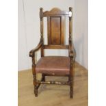 Oak and brown leather upholstered armchair {120 cm H x 57 cm W x 47 cm D}.
