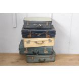 Collection of five suitcases.