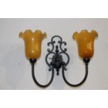 Pair of black metal wall lights with amber tulip shades {36 cm H x 45 cm W x 22 cm D}.