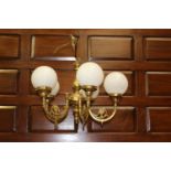 Solid brass five branch chandelier with white glass globes {53 cm H x 60 cm Dia.}.