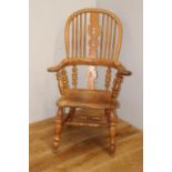 Oak Windsor armchair raised on turned legs with turned stretcher{110 cm H x 68 cm W x 48 cm D}.