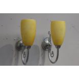 Pair of chrome wall lights with yellow shades {32 cm H x 10 cm W x 26 cm D}.