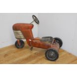 Metal pedal tractor {72 cm H x 96 cm W x 52 cm D}.