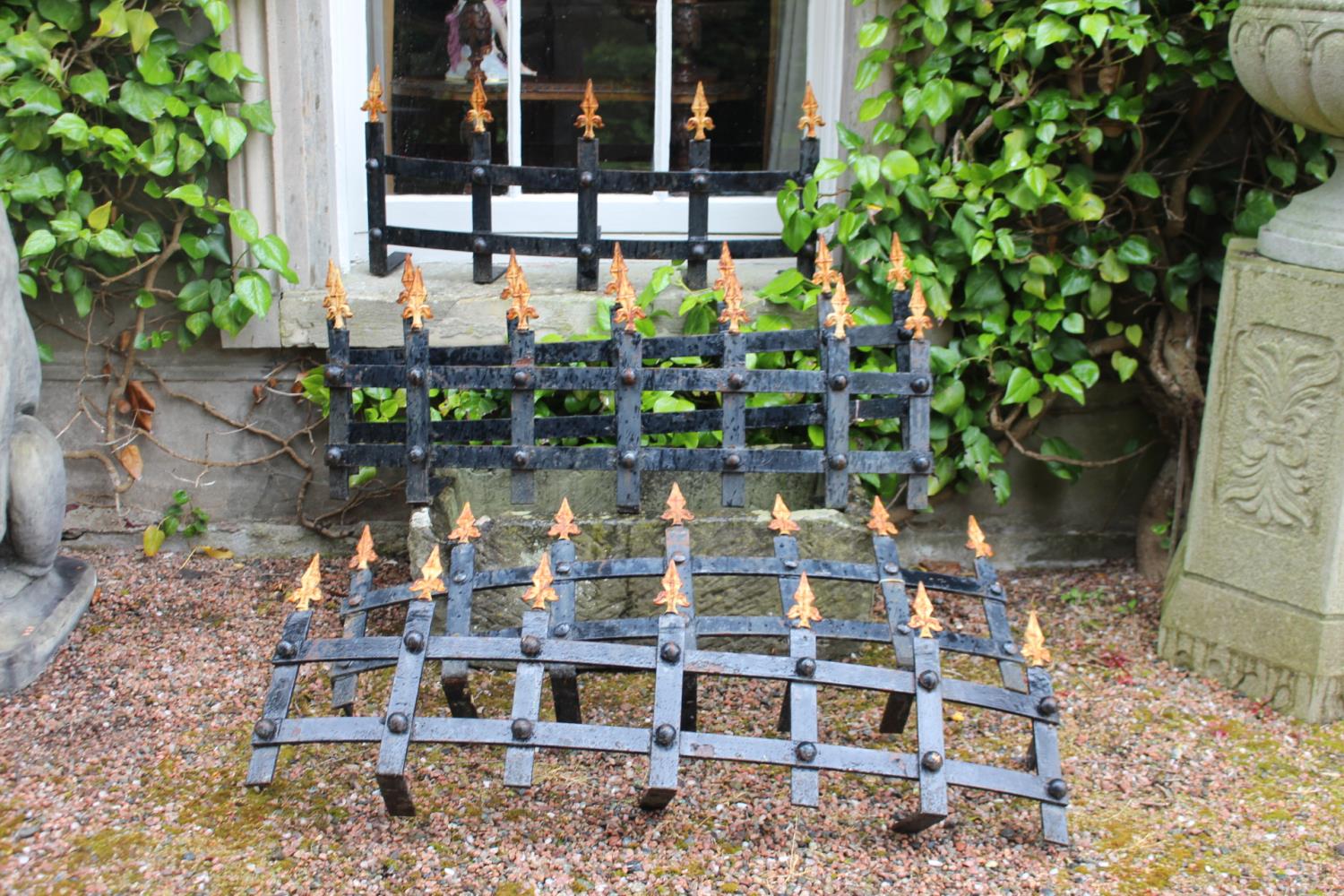 Four wrought iron window guards with spiked finials {43 cm H}.