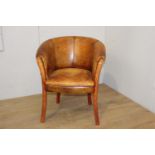 Wooden and tan leather upholstered tub chairs raised on curved tapered legs {82 cm H x 66 cm W x