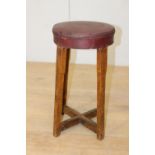 Oak and red leather upholstered stool {59 cm H x 34 cm Dia.}.