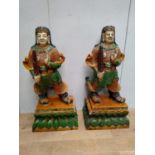 Pair of composition glazed models of Oriental warriors on green stone base. {136 cm H x 40 cm D x 57