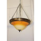 Brass hanging uplighter with amber shade {18 cm H x 39 cm Dia.}.