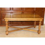 Oak coffee table raised on turned legs {59 cm H x 120 cm W x 67 cm D}.
