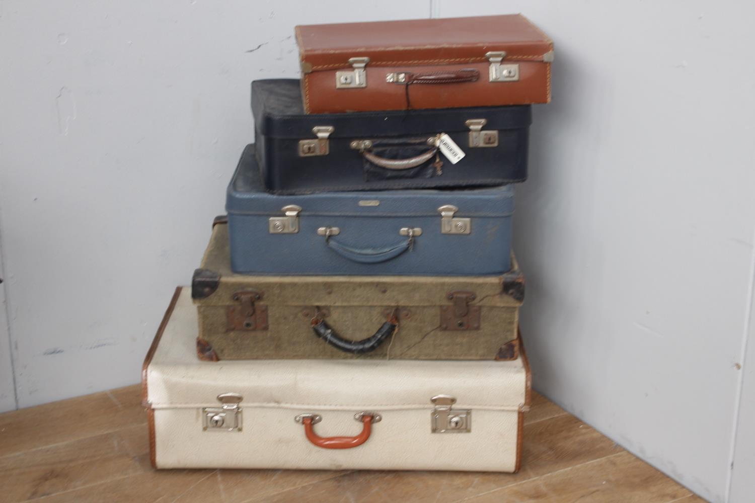 Collection of five suitcases.