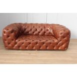 Deep buttoned leather upholstered Chesterfield sofa {70 cm H x 200 cm W x 65 cm D}.