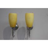 Pair of chrome wall lights with yellow shades {32 cm H x 10 cm W x 26 cm D}.