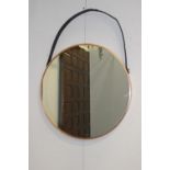 Copper framed mirror with hanging leather strap {76 cm Dia. X 5 cm D}.