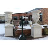 Pair of large composition stone urns on bases {228 cm H x 80 cm Dia.}.