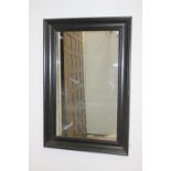 Black wall mirror {90 cm H x 60 cm W x 5 cm D}.