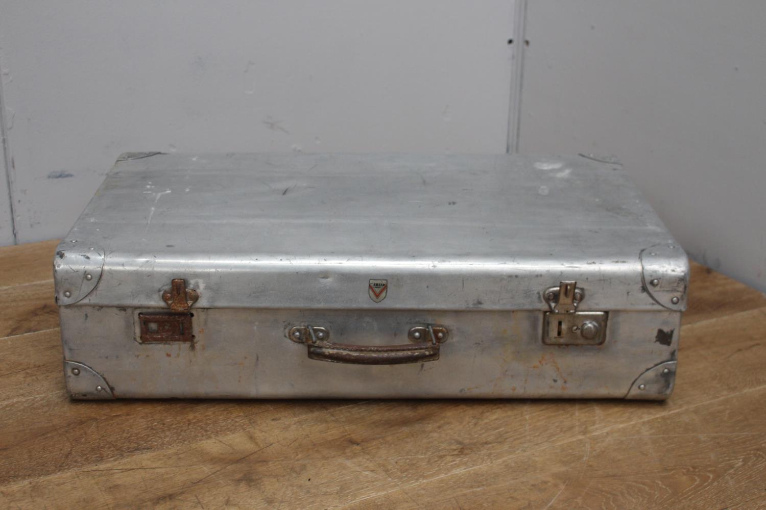 White metal suitcase {20 cm H x 74 cm W x 43 cm D}.