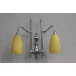 Pair of chrome wall lights with yellow shades {46 cm H x 48 cm W x 22 cm D}.