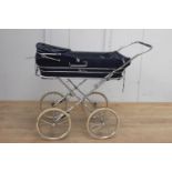 Silver Cross child's pram with white rubber tyres {120 cm H x 112 cm W}.