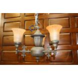 Polished metal three branch chandelier with orange glass shades {40 cm H x 50 cm Dia.}.