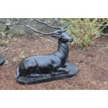 Cast iron model of a seated Stag. {80 cm H x 90 cm W x 65 cm D}.