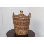 Wine bottle in wicker case {54 cm H x 42 cm Dia.}.