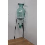 Glass vase on metal stand {100 cm H x 26 cm Dia.}.