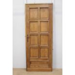 Oak door with nine panels and mounted with brass handles {200 cm H x 80 cm W x 5 cm D}.