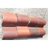 Collection of seventy five glazed terracotta ridge tiles { 15cm H X 31cm W X 30cm D }.