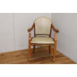 Wooden and cream leather upholstered studded armchair {87 cm H x 59 cm W x 47 cm D}.