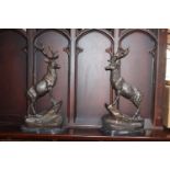 Pair of bronze models of stags standing on a craggy outcrop, mounted on a marble base. { 70cm H X