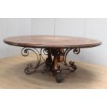 Oak and walnut veneered centre table raised on scrolled wrought iron base decorated with acanthus