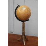 World globe on brass stand {55 cm H x 23 cm Dia.}.