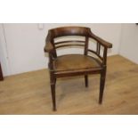 Wooden armchair with brown leather upholstered seat {79 cm H x 66 cm W x 49 cm D}.