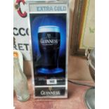 Experience Extra Cold Guinness chrome and Perspex light up advertising sign {43 cm H x 17 cm W}.
