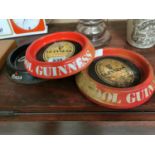 Four tin plate advertising ash trays - Guinness and Bass {21 cm Dia.}.