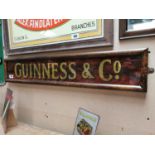 Guinness & Co. reversed painted glass framed advertising sign {19 cm H x 97 cm W}.