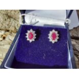 Pair of 18ct. white gold ruby and diamond earrings Estimated: weight of diamonds 60points /.6ct