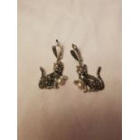 Pair of silver and marcasite earrings in the form of cats with ruby eyes