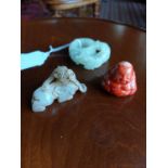 Collection of three small Oriental pieces - two jade pieces and one red coral Budha