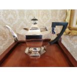 English silver teapot Hallmarked in Sheffield Walker and Hall {19 cm H x 30 cm W}.
