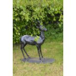 Cast iron model of a Deer on an oval plinth {125 cm H x 100 cm W x 43 cm D}.