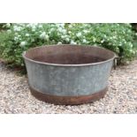 Metal planter of round form with handles { 26cm H X 60cm Dia }.