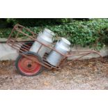 Milk churn trolley and two aluminium creamery cans 100cm H X 190cm W X 60cm D ].